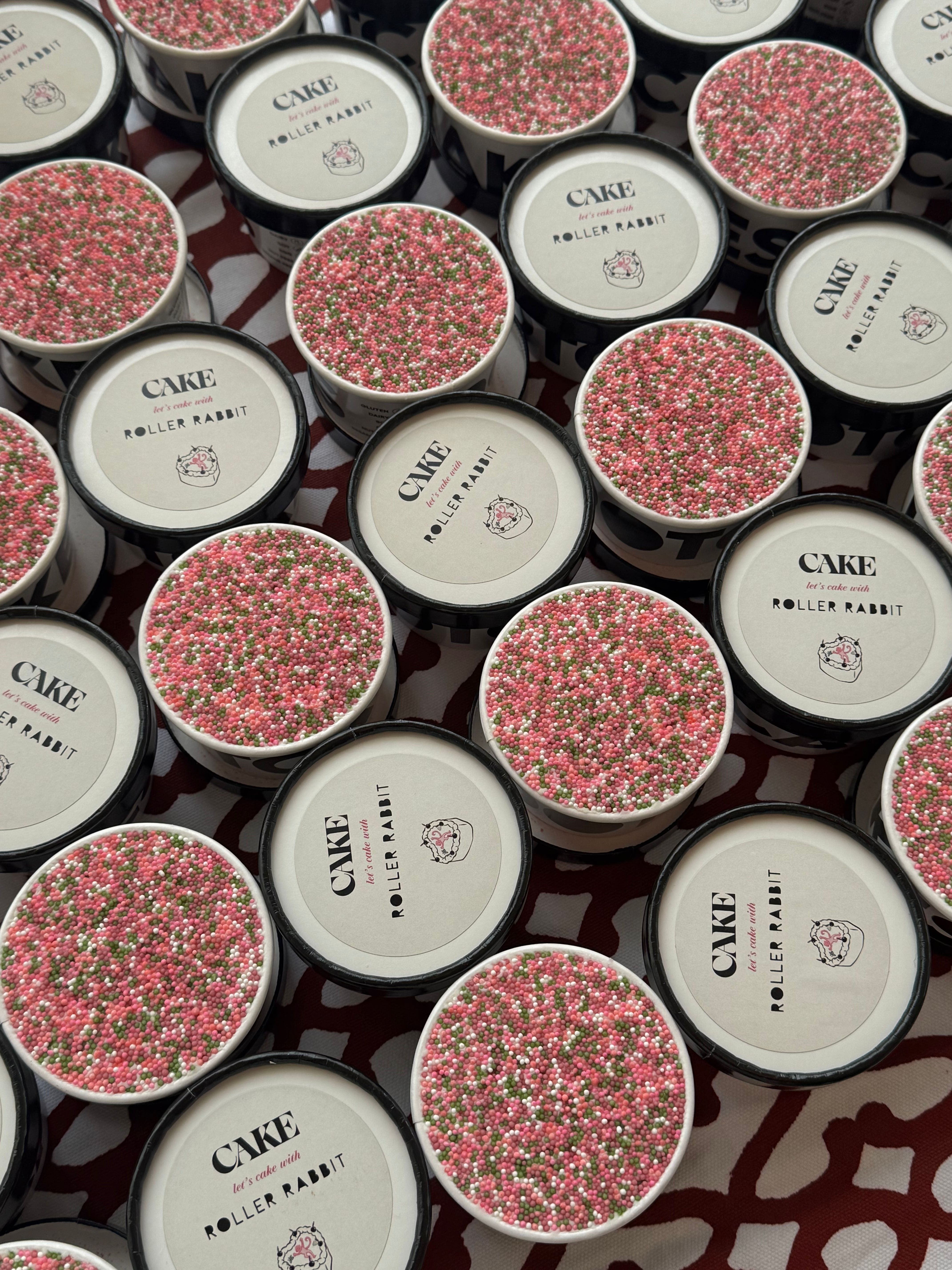 CAKE x Roller Rabbit branded dessert cups topped with pink, green, and white sprinkles for a Mother’s Day celebration.